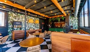 a restaurant with tables and chairs and a bar at DWO Nopal in Puerto de la Cruz