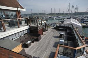 a deck of a boat with benches and boats at Royal Southern Yacht Club in Hamble