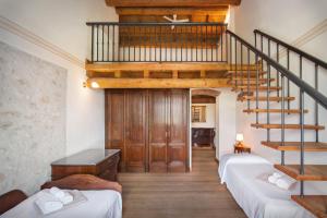 een kamer met 2 bedden en een wenteltrap bij Cà Cantoni With Pool in Garda