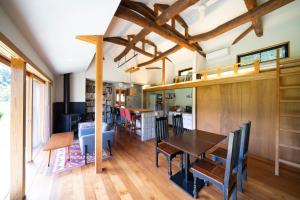 a dining room and living room with a table and chairs at Isumi Enokisawa -いすみ 四季の家 榎澤- ペット可 in Isumi