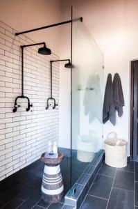 a glass shower in a bathroom with a sink at Jock Safari Lodge in Skukuza
