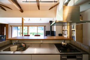 a kitchen with a sink and a stove at Isumi Enokisawa -いすみ 四季の家 榎澤- ペット可 in Isumi