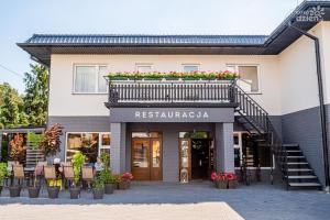 una facciata di un edificio con balcone di Hotel POD RÓŻAMI a Jedlnia-Letnisko