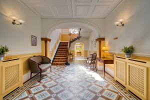 a hallway with stairs and chairs in a building at The Leathes Head Hotel in Keswick