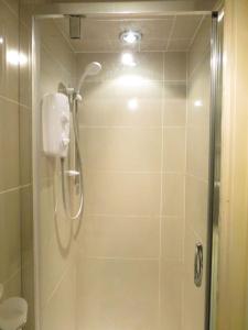 a bathroom with a shower with a shower head at Modern split level flat in Croydon (south) London in London