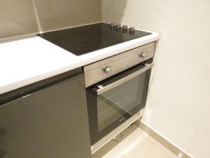 a kitchen with a black sink and a counter at Modern split level flat in Croydon (south) London in London