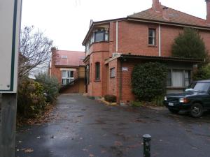 an empty driveway in front of a brick house at Launceston Backpackers in Launceston