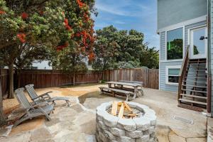 a patio with two chairs and a fire pit at Beach Unit wPrivate Hot Tub Fire Pit BBQ Walk 2 Food & Activities in Half Moon Bay