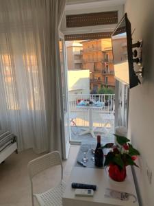a room with a table and chairs and a window at La Piazza BeB in Tropea