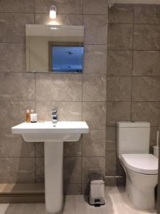 a bathroom with a sink and a toilet at The Wheel House in Mevagissey