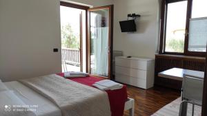 a bedroom with a bed and a bathroom with a television at Appartamenti a Bardolino in Bardolino +63 photos