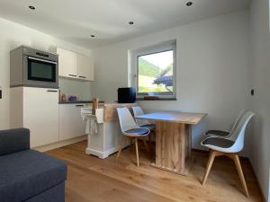 a kitchen with a table and chairs in a room at Alpine Apartment Belluca in Gries im Sellrain