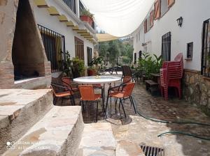 an outdoor patio with a table and chairs at Alojamiento Rural El Molino De La Cerrada in Castril