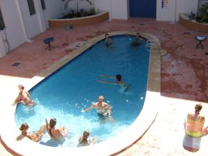 a group of people swimming in a swimming pool at Beatty Lodge in Perth