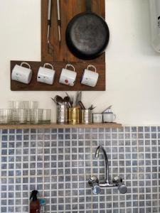 a kitchen counter with a sink and a pot rack at Santuario Patagonia in El Bolsón