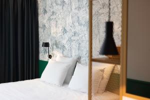 Een bed of bedden in een kamer bij Yalo Urban Boutique Hotel Gent