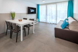 a living room with a white table and a couch at Rentalmar Salou Playa Family Suites & Pool in Salou