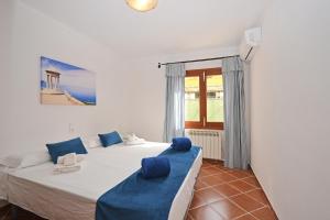 a bedroom with two beds and a window at Villa Jaume in Alcudia +26 photos