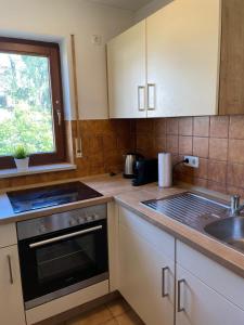 a kitchen with a sink and a stove top oven at Modernes Apartment im Herzen von Würzburg in Würzburg