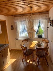 a kitchen with a table and chairs and a window at Bergmannsruh in Clausthal-Zellerfeld