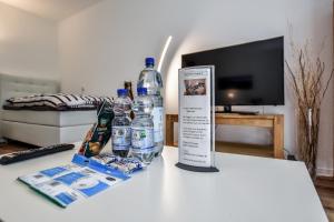 a group of bottles of water on a table at Domicile Cologne in Cologne