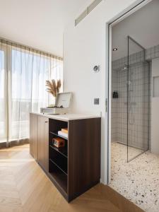 
a bathroom with a sink, toilet, and cabinet at Yalo Urban Boutique Hotel Gent in Ghent
