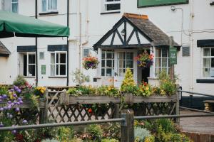 a house with flowers in front of it at The Kings Arms Otterton in Budleigh Salterton