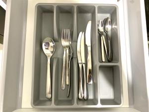 a tray with silver cutlery in a drawer at KL Gateway Residency in Kuala Lumpur