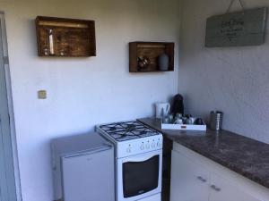 a kitchen with a stove and a counter top at Charming 2-Bed Cabin in Domfront-en-Poiraie in Perrou