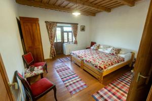 a bedroom with a bed and a table and chairs at Csenger Vendégházak in Mátraverebély