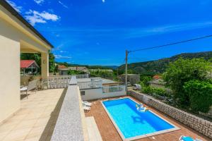 a swimming pool on the balcony of a house at Villa Marta in Grižane