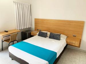 Llit o llits en una habitació de Don David Sabana Hotel