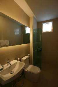 a bathroom with a toilet and a sink and a shower at Apo Hotel in Krabi town