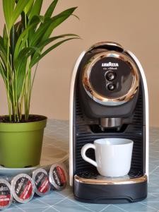 a coffee maker with a cup on a counter at Acqua Chiara in Alghero