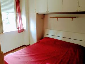 ローマにあるTre Colli Romaの小さなベッドルーム(赤いベッド1台、窓付)