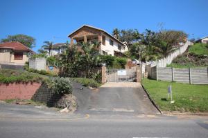a house with a fence and a driveway at Surf and Sand - Fish Eagle in Ramsgate