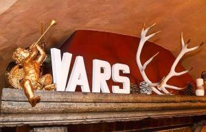 a nars sign on top of a shelf with antlers at La Vieille Auberge in Vars