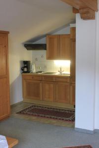 a kitchen with wooden cabinets and a sink at Appartement Huber in Pertisau