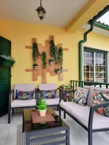 a patio with three chairs and a table at Eagle House in Sao Pedro de Tomar