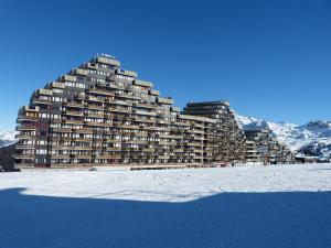 a large building sitting on top of a snow covered beach at travelski home select - Vue Mont Blanc in Aime-La Plagne