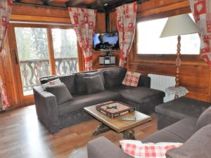 a living room with a couch and a table at 1 Authentique chalet, le Mirador in Les Gets