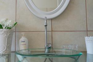 a glass sink in a bathroom with a mirror at Blue Star Villa in Tergniet