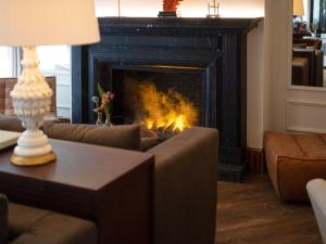 a living room with a fire in a fireplace at Only YOU Hotel Valencia in Valencia