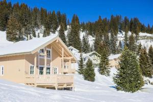 a house in the snow with trees in the background at Residence les chalets de Flaine Hameau - maeva Home in Flaine