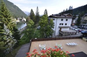 a view from a balcony of a building and a river at Hotel Cristallo in Madonna di Campiglio