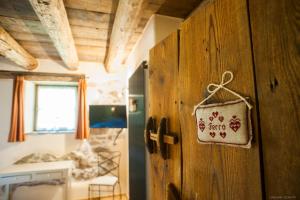 a room with a wooden wall with a sign on it at Maso Franceschella in Carano