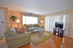 a living room with a couch and a television at Thunder Island 75B condo in Ocean City