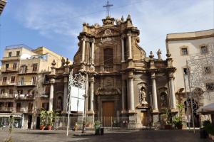 uma antiga igreja numa cidade com edifícios em Vespri Luxury Rooms & Suites em Palermo