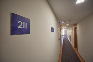 a hallway in a building with a sign on the wall at Santa Ponsa Pins in Santa Ponsa