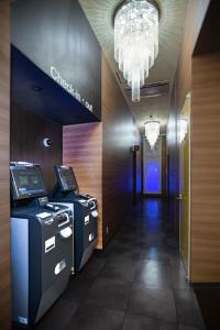 a hallway with two atm machines in a building at Pinpon Hotel Hiroshima in Hiroshima +87 photos
